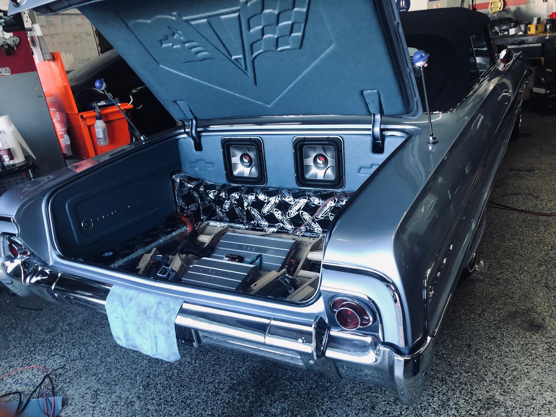 A car with the trunk open and speakers in the back