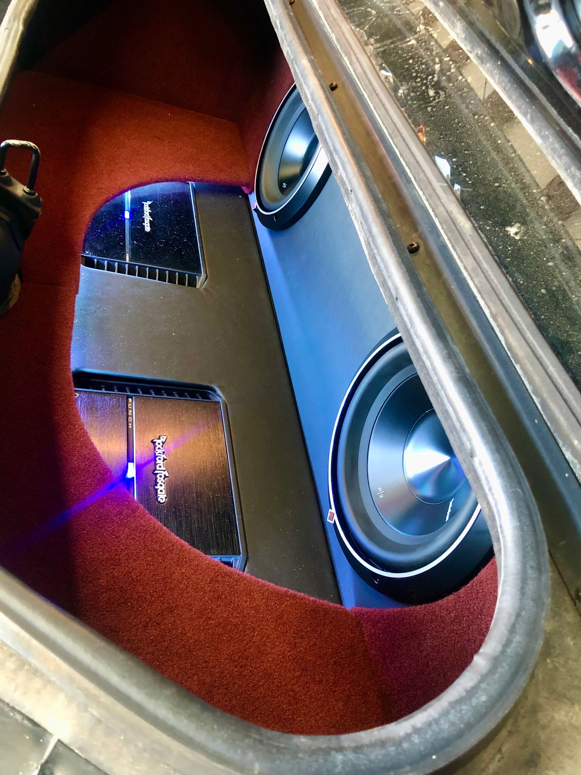 A subwoofer is sitting in the back of a car