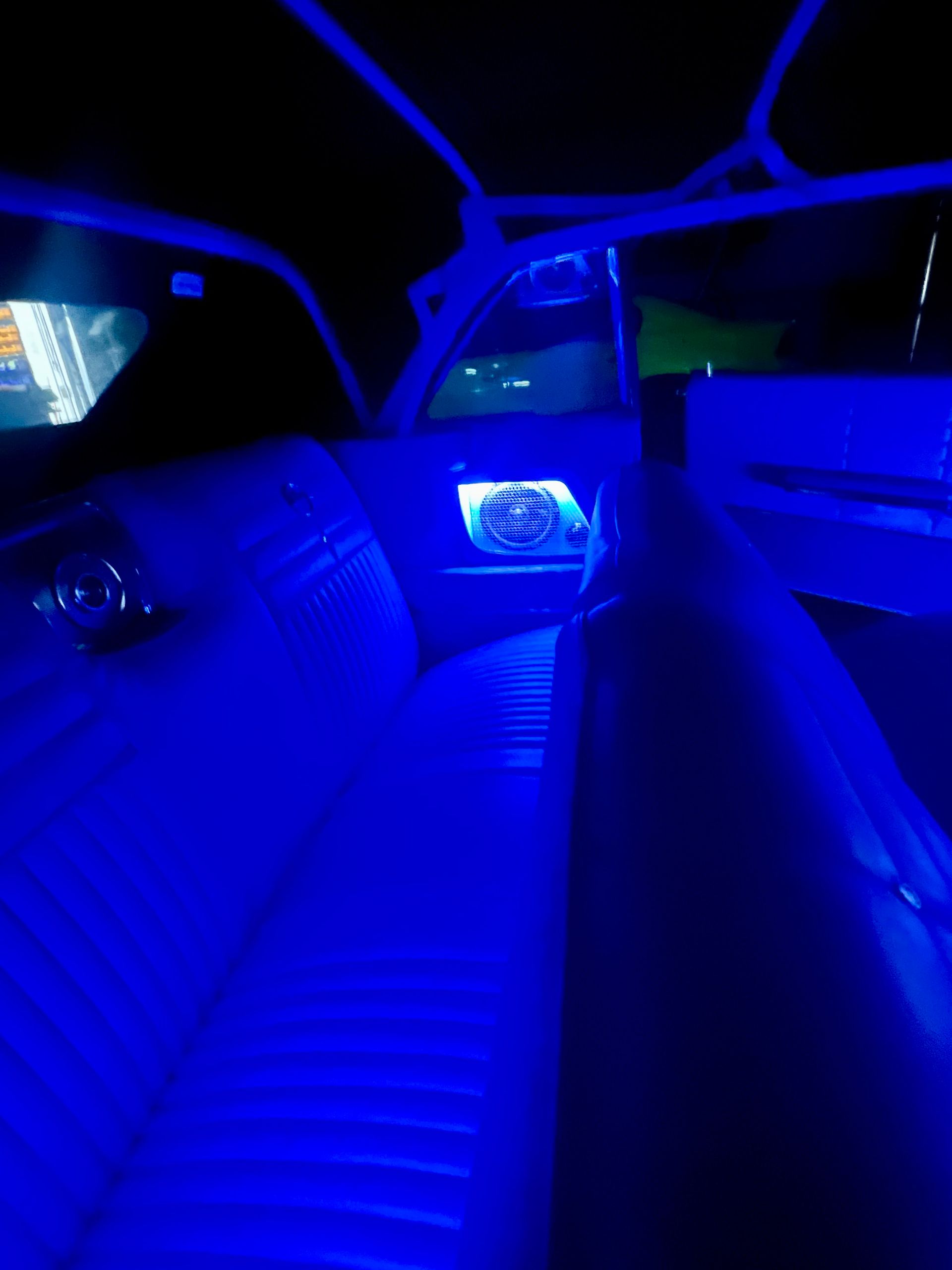 The inside of a car is lit up with blue lights.
