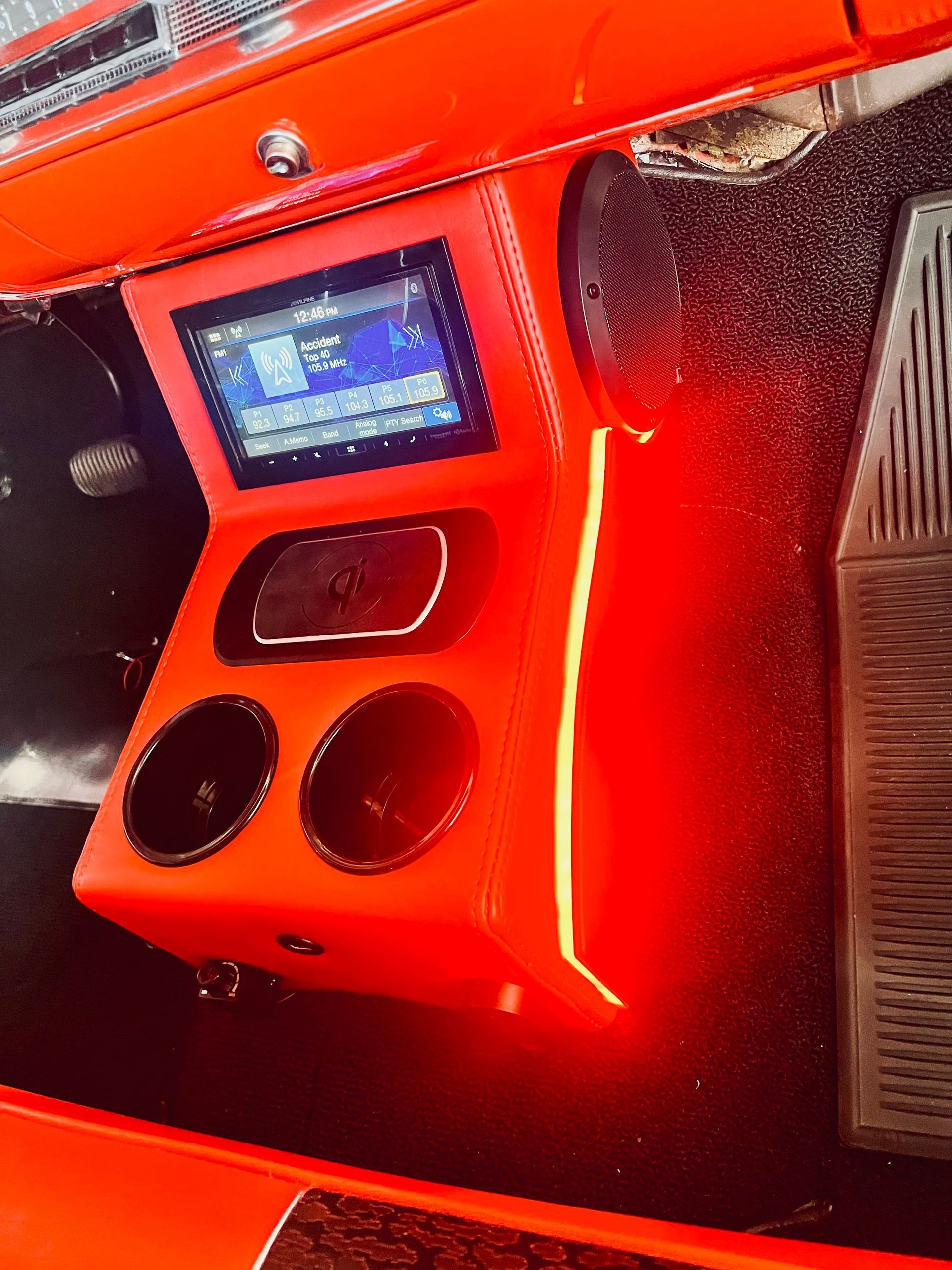 An orange box with speakers and a screen on top of it