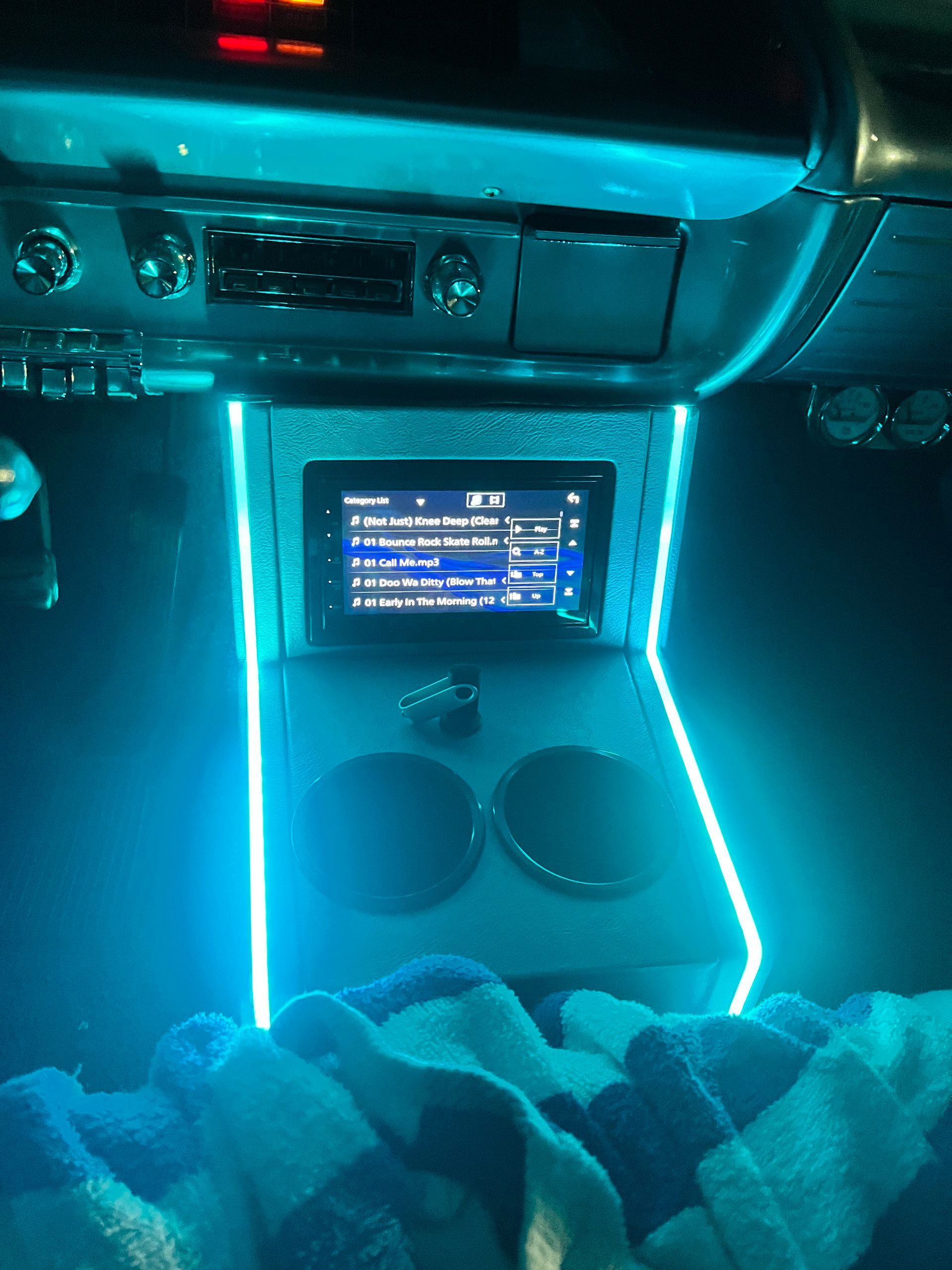 A blue light is shining on the dashboard of a car