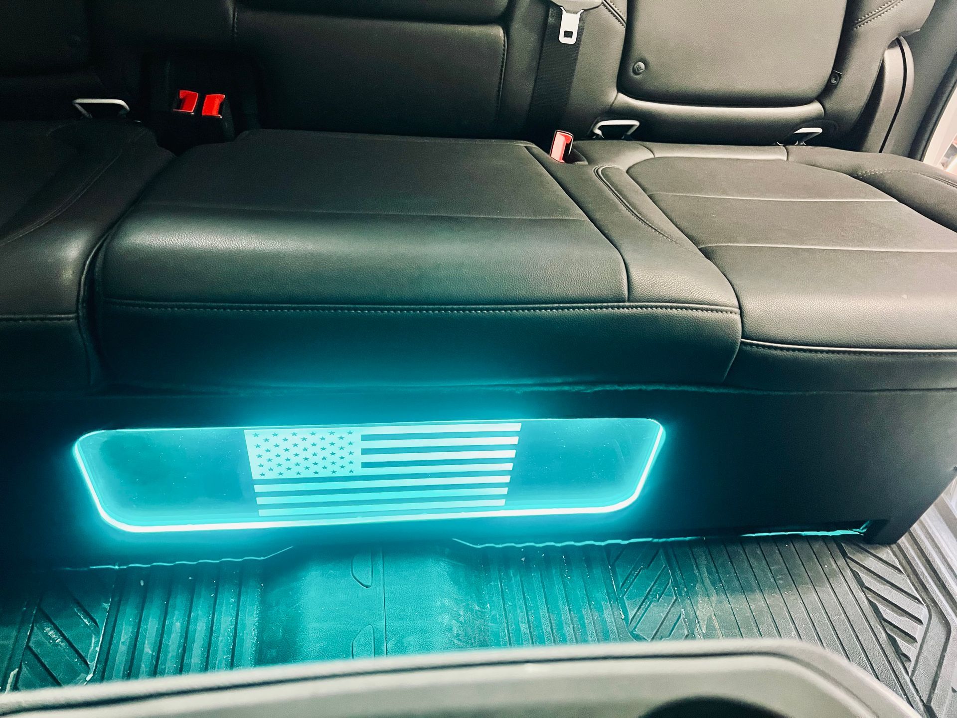 The back seat of a car with a blue light on it