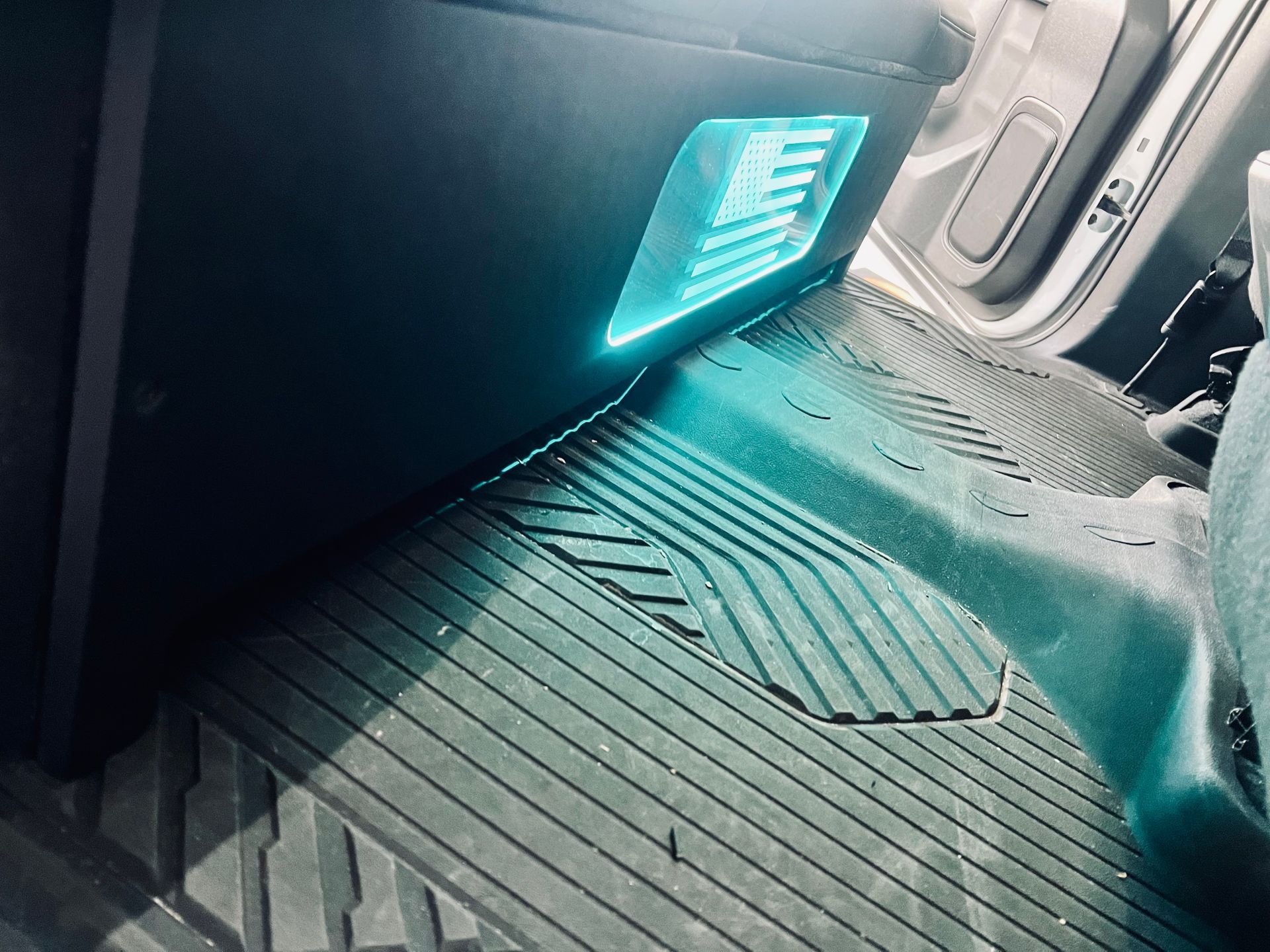The inside of a car with a blue light on the floor