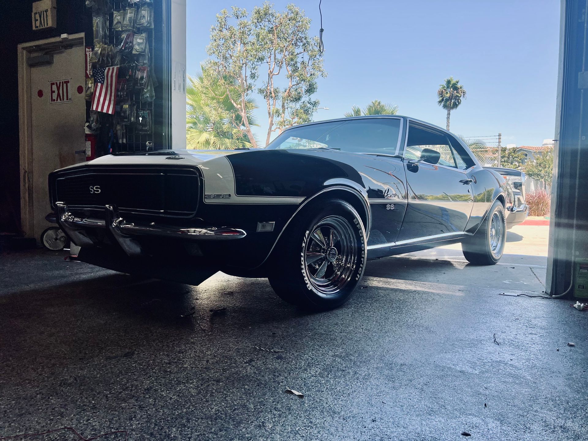 A black and white car is parked in a garage.