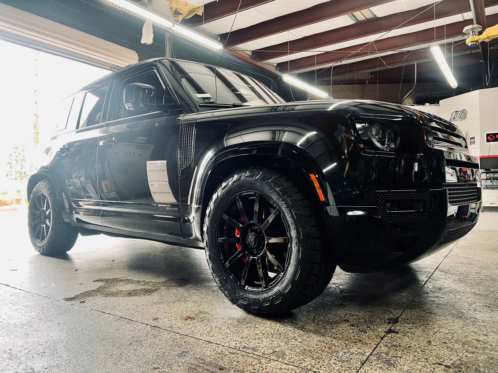 A black suv is parked in a garage.