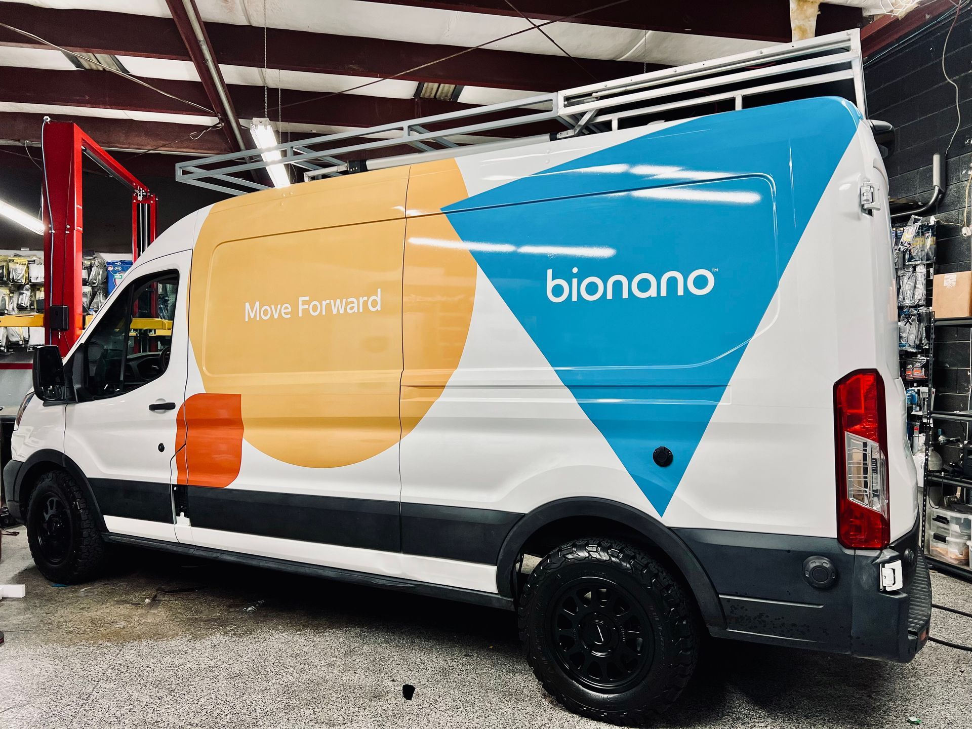 A bionano van is parked in a garage.