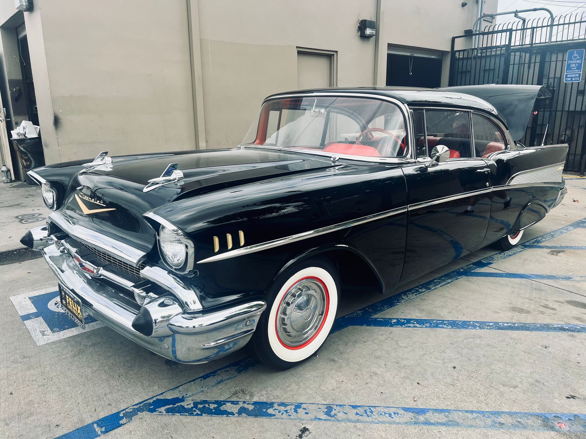 A black car is parked in a handicapped parking spot
