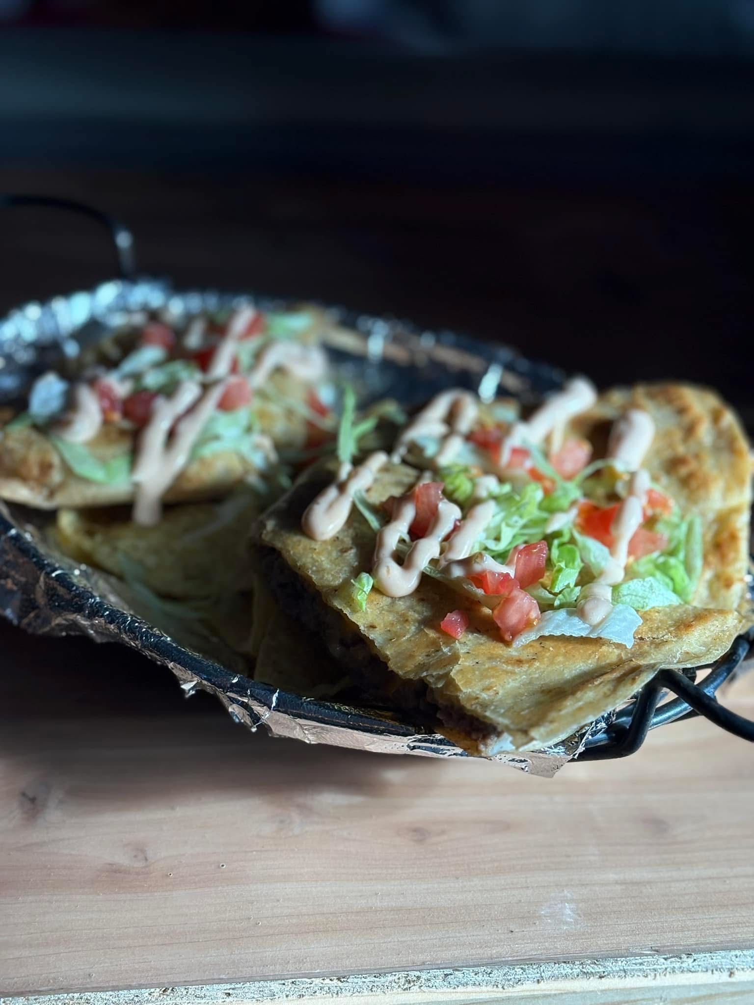 A close up of a plate of food on a wooden table.