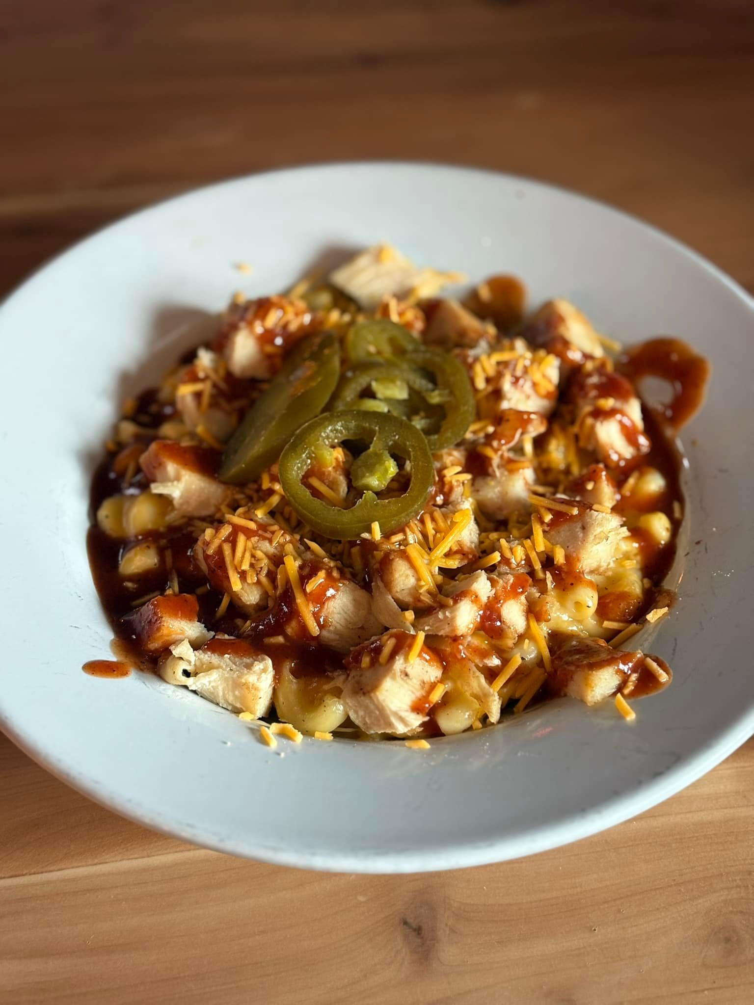 A close up of a plate of food on a wooden table.
