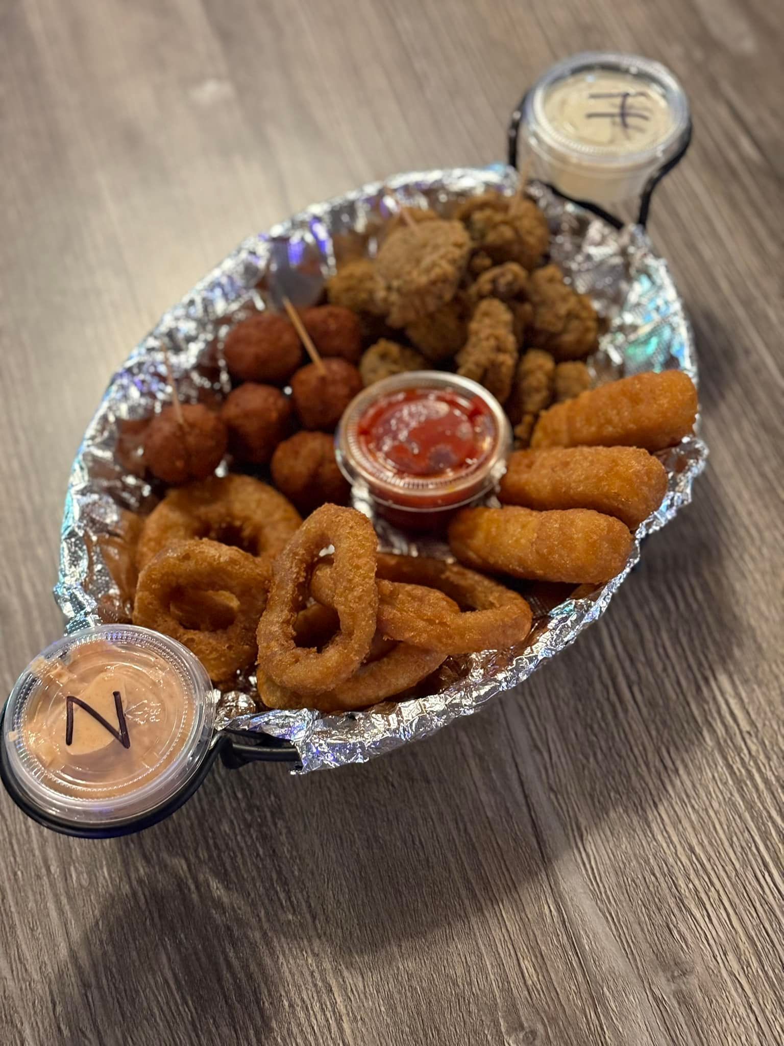 A plate of food with sauces on a table.