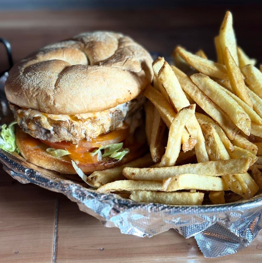 A hamburger and french fries on a plate on a table