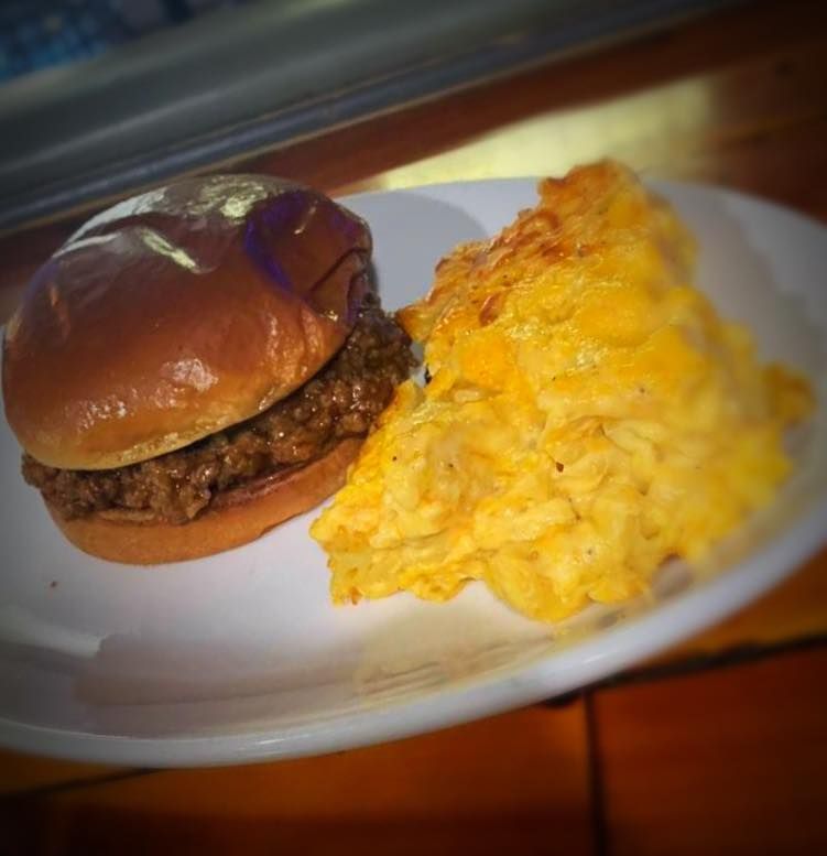 A hamburger and mashed potatoes on a white plate