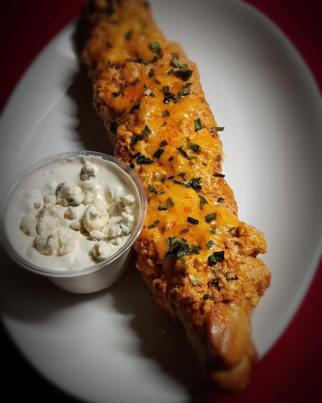 A plate of food with a dipping sauce on it