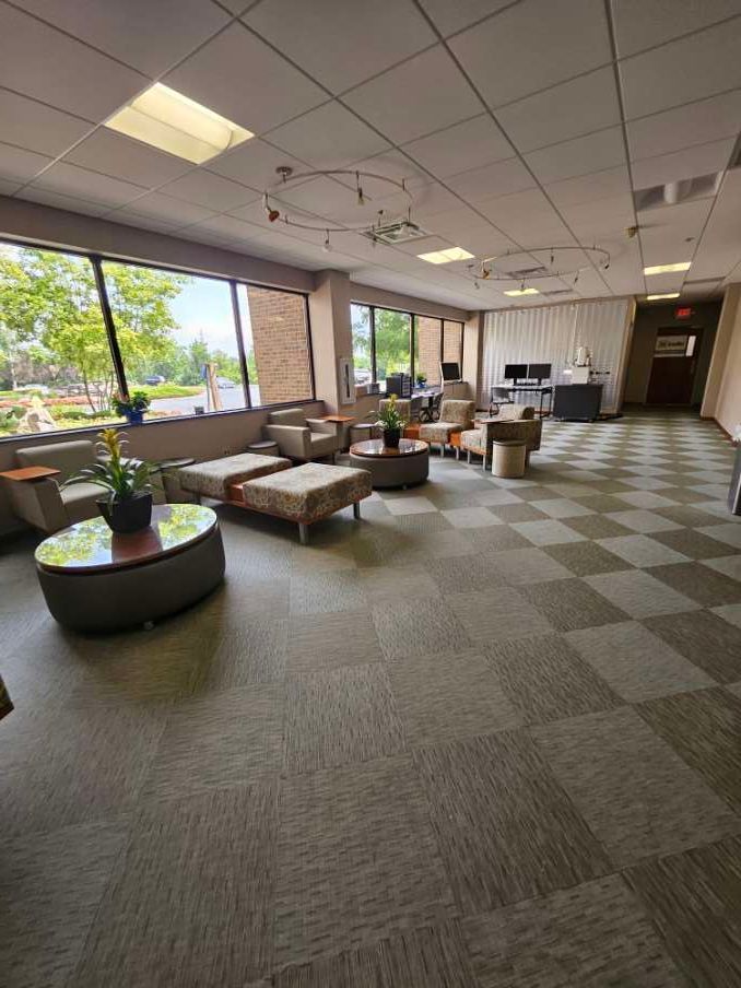 A large room with a lot of furniture and a checkered floor.