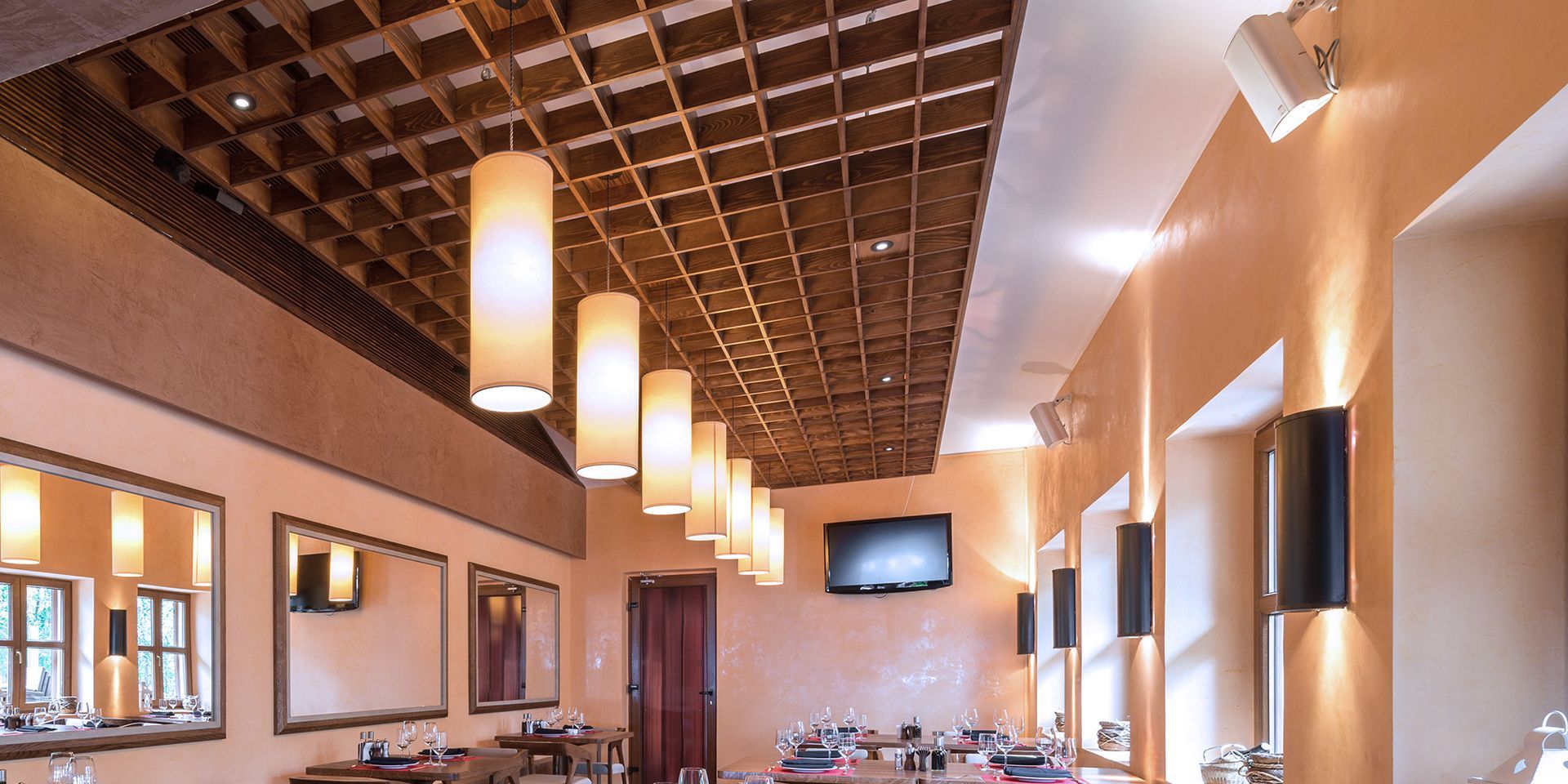 A restaurant with a ceiling that has a lot of lights hanging from it