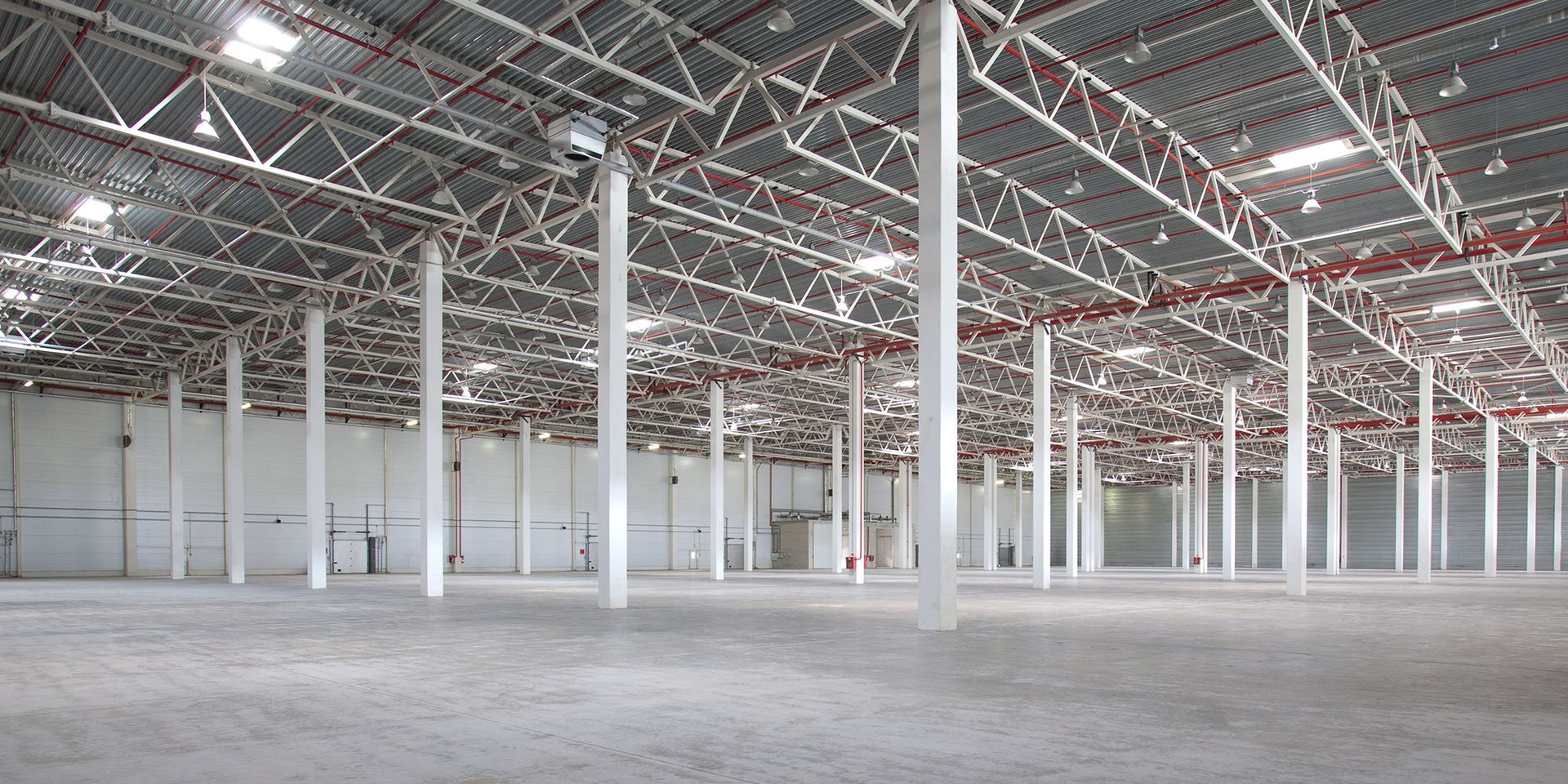 A large empty warehouse with columns and a roof.