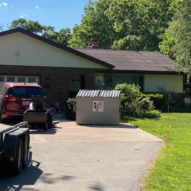 a house with a dumpster in front of it