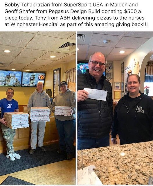 A group of people holding pizza boxes and a check in a restaurant