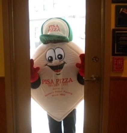 A person in a pizza mascot costume is standing in a doorway