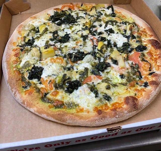 A pizza in a box that says ' we 're only as good as our ' on it