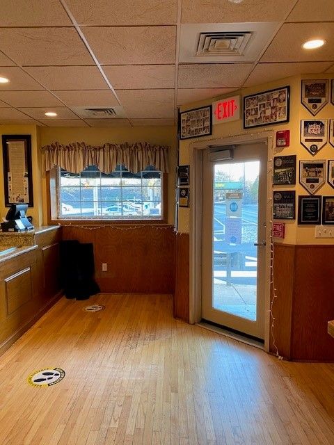 An empty room with an exit sign above the door