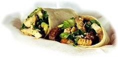 A close up of a wrap with chicken and vegetables on a white plate.