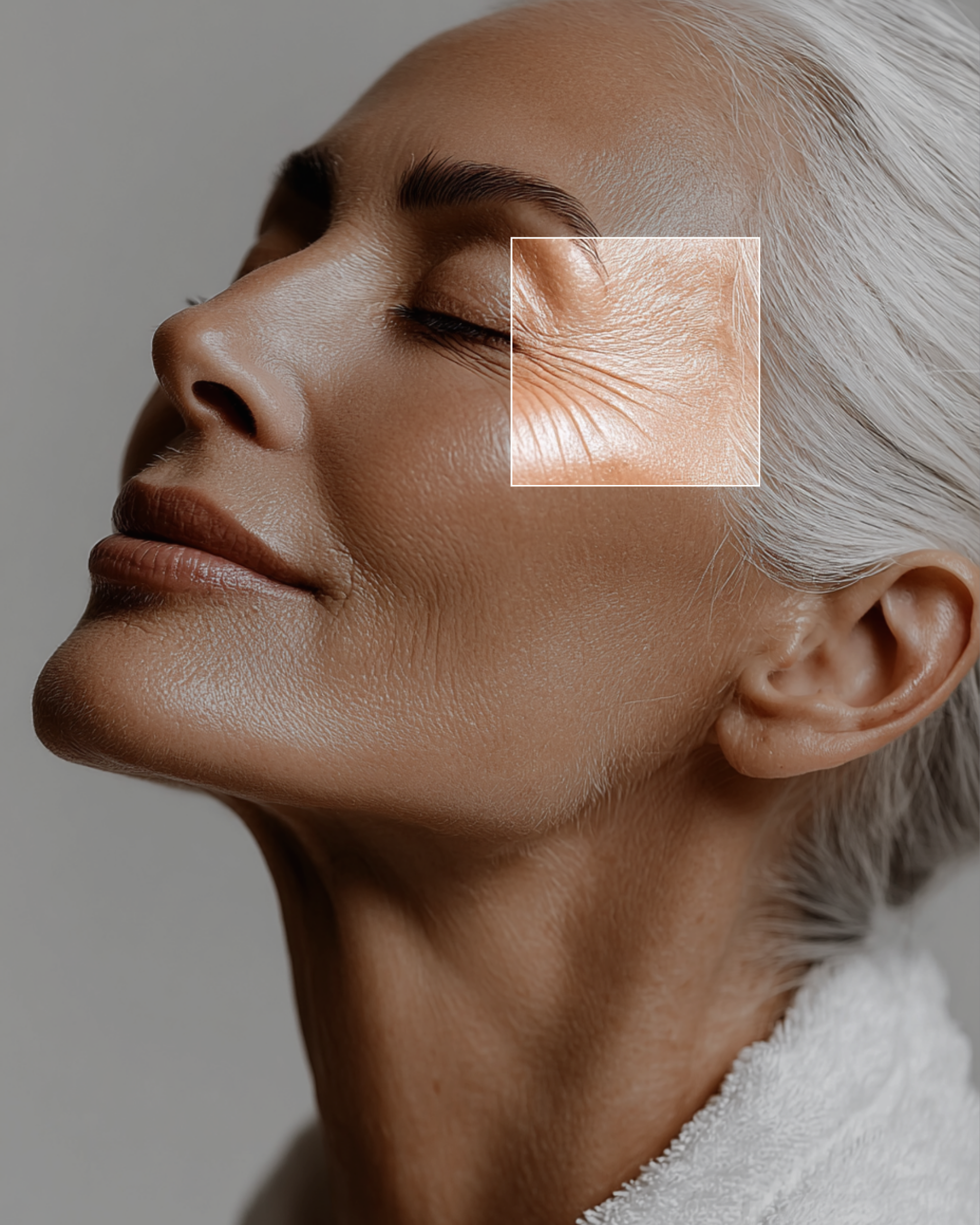 A person touching their face, highlighting skincare with a gentle expression against a light blue background.