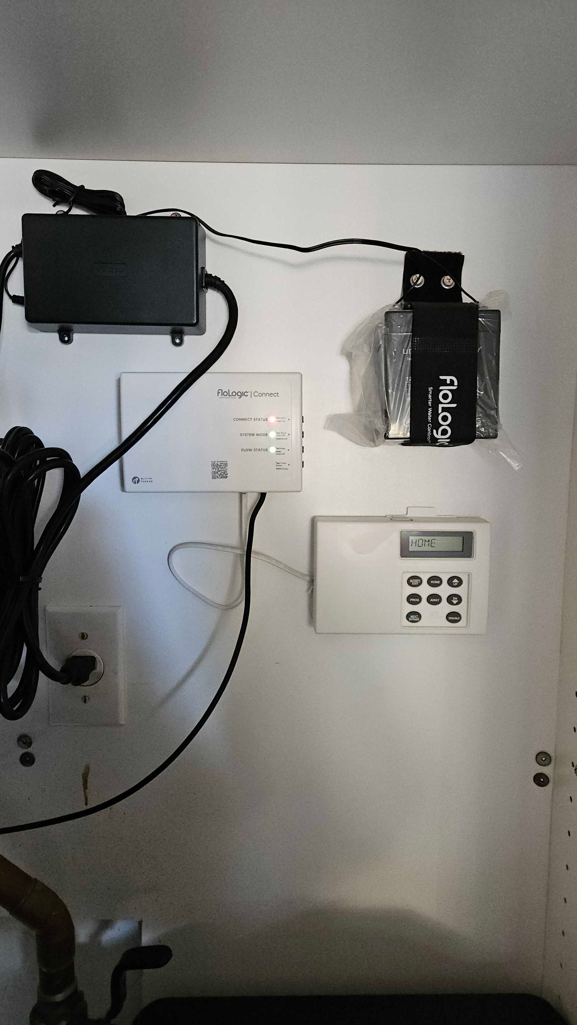 A wall with a bunch of wires hanging from it