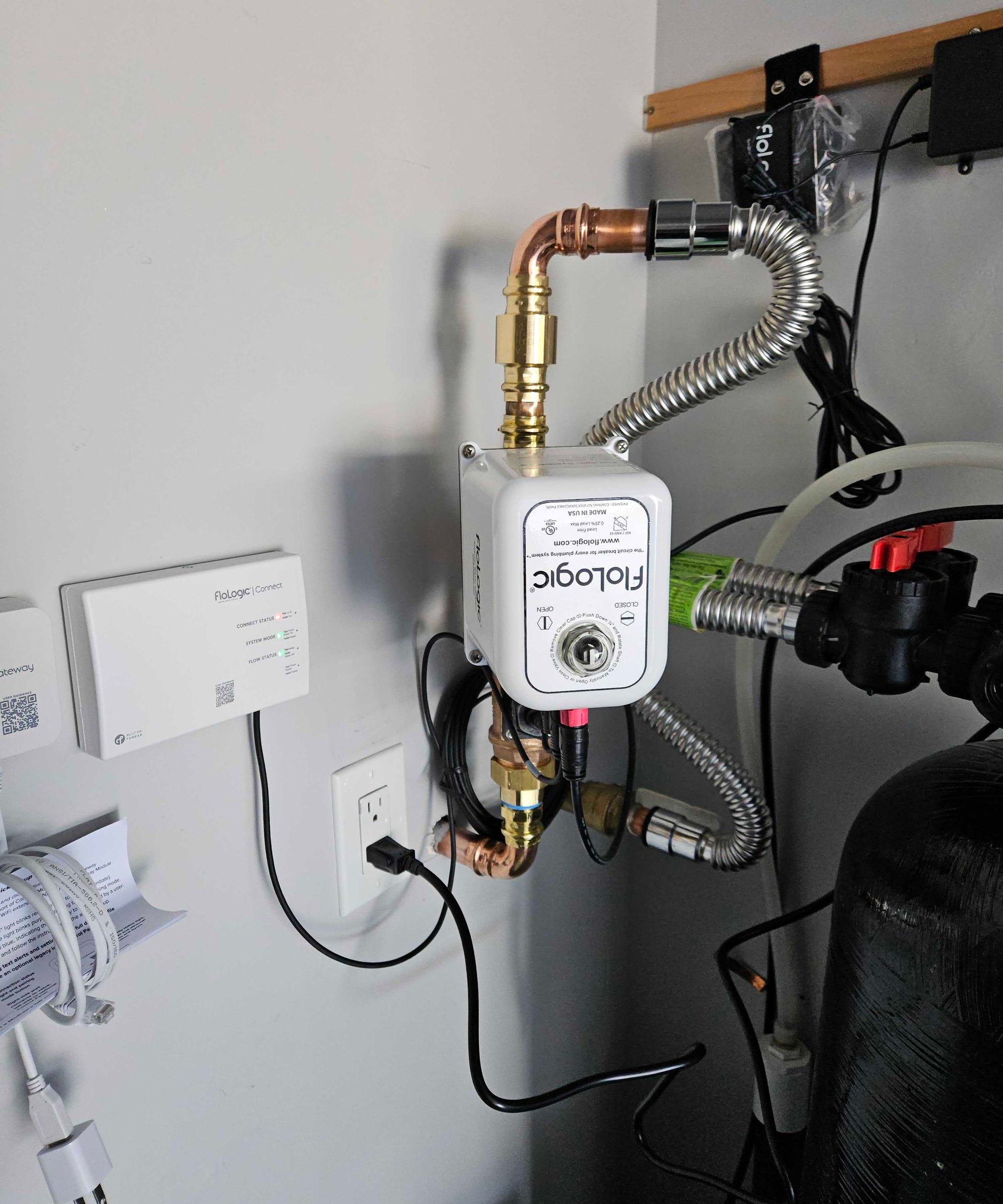 A water pump is connected to a wall with a hose attached to it.