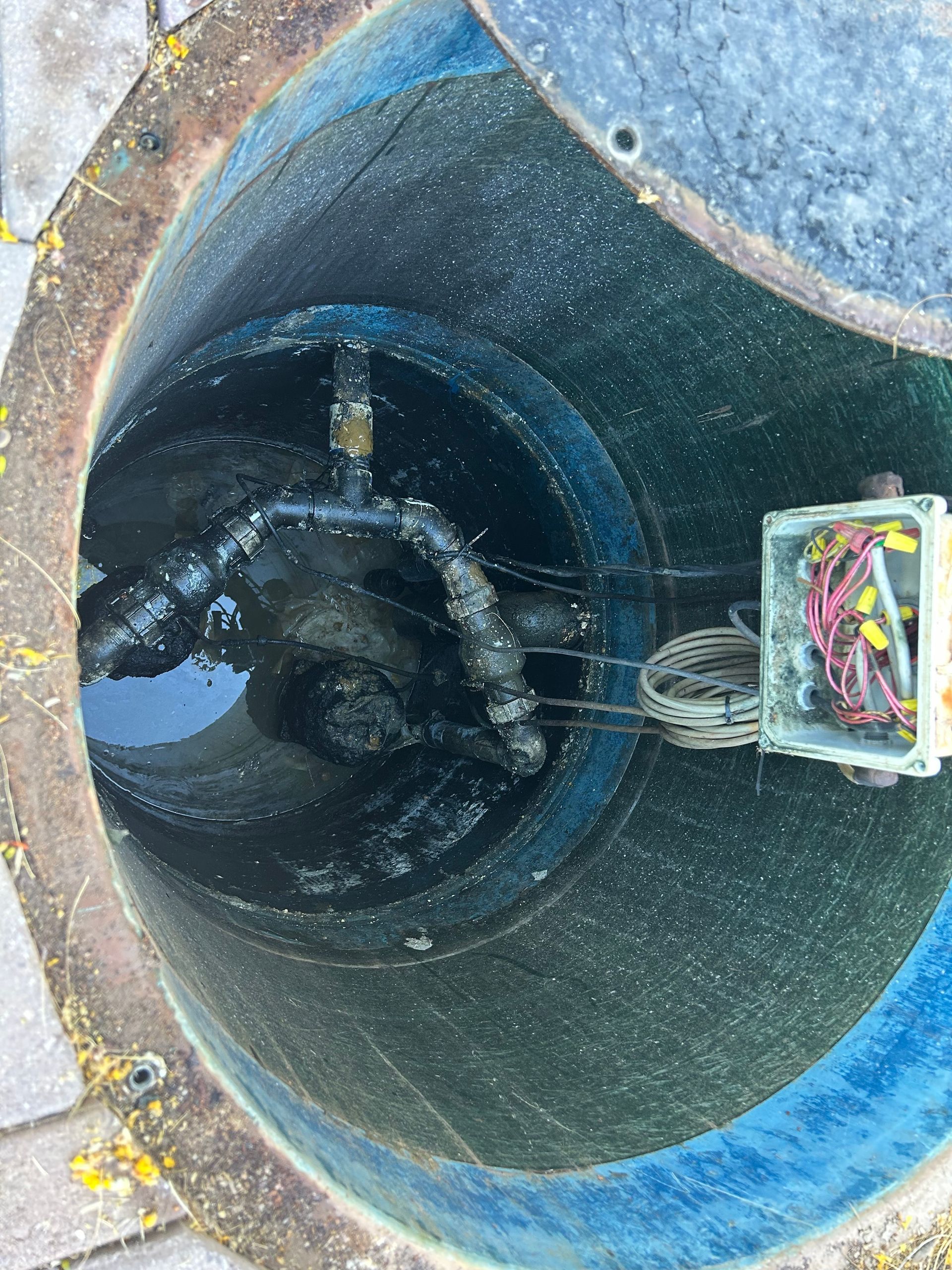 A manhole cover with a box inside of it.