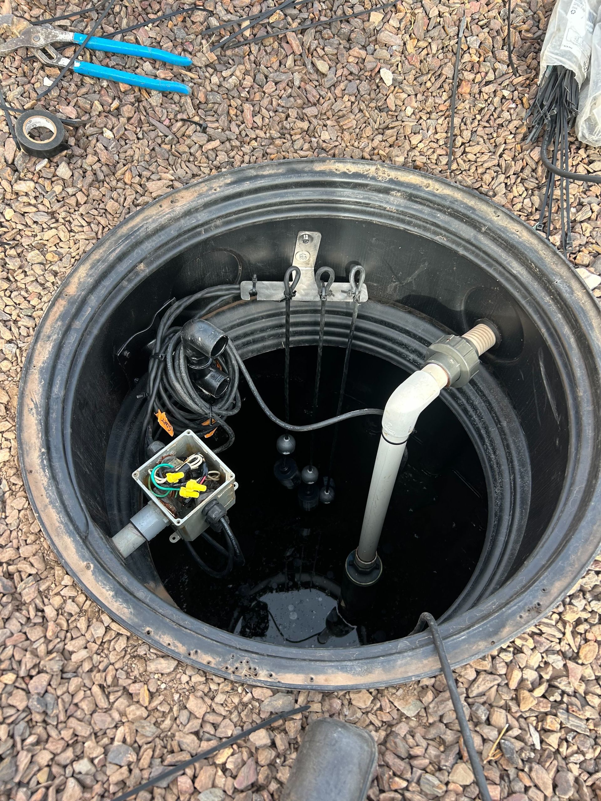 A manhole cover with a pump inside of it.