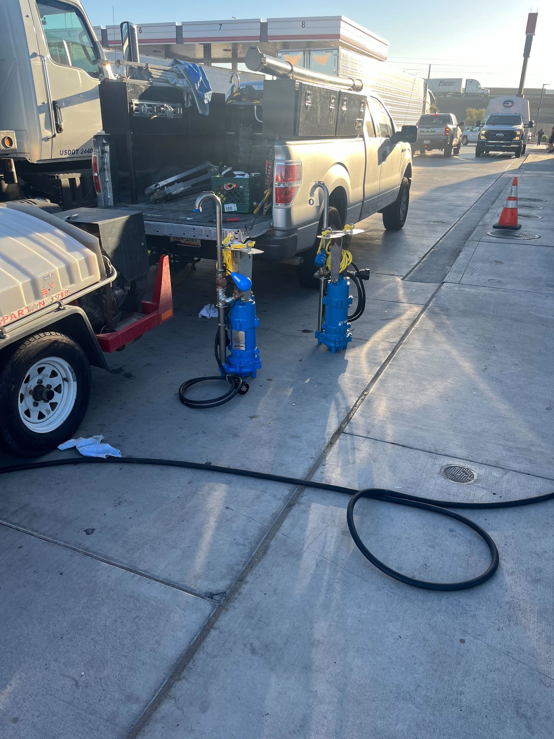 A hose is spraying water into a drain.