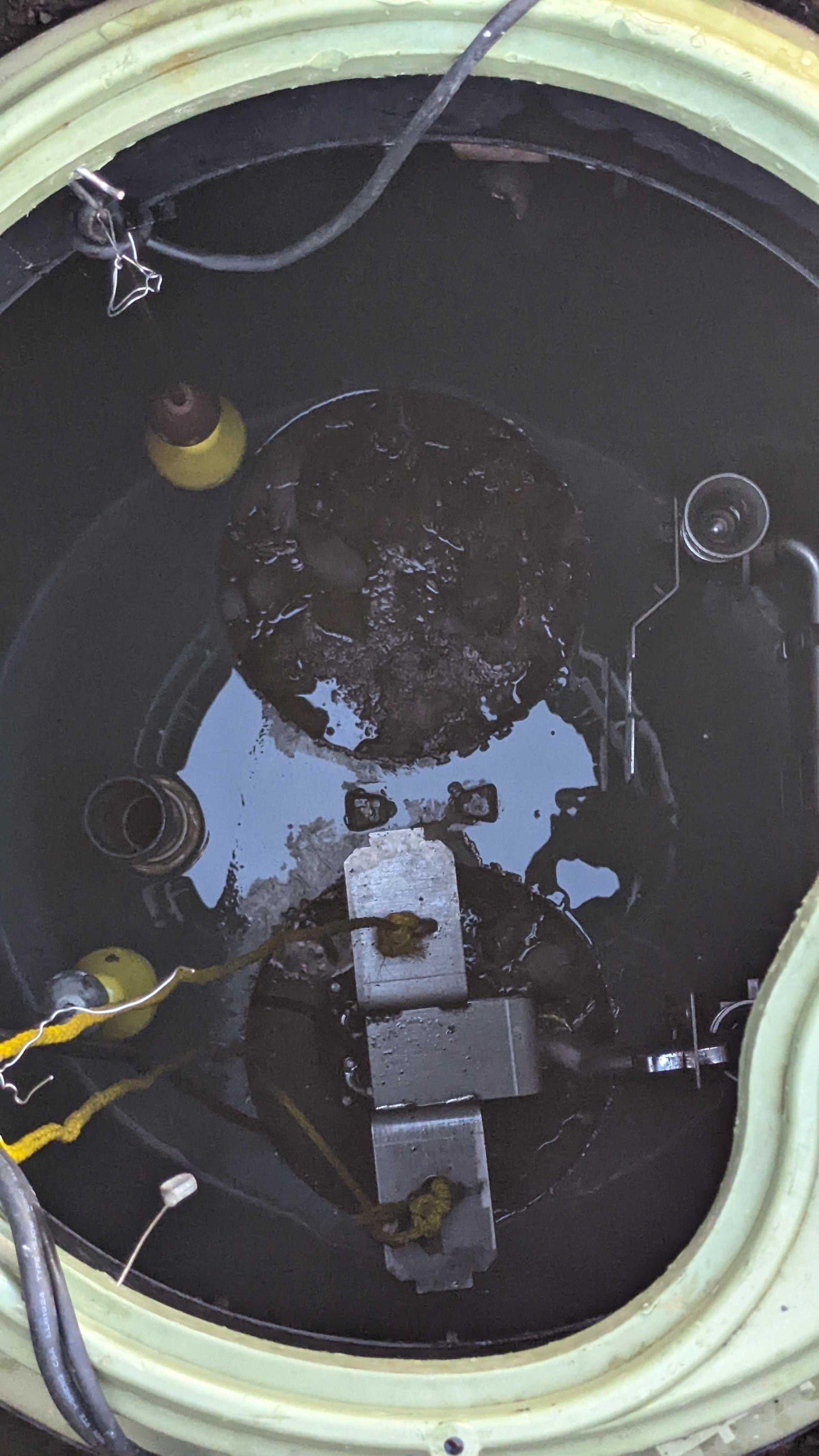 A close up of a well filled with water.