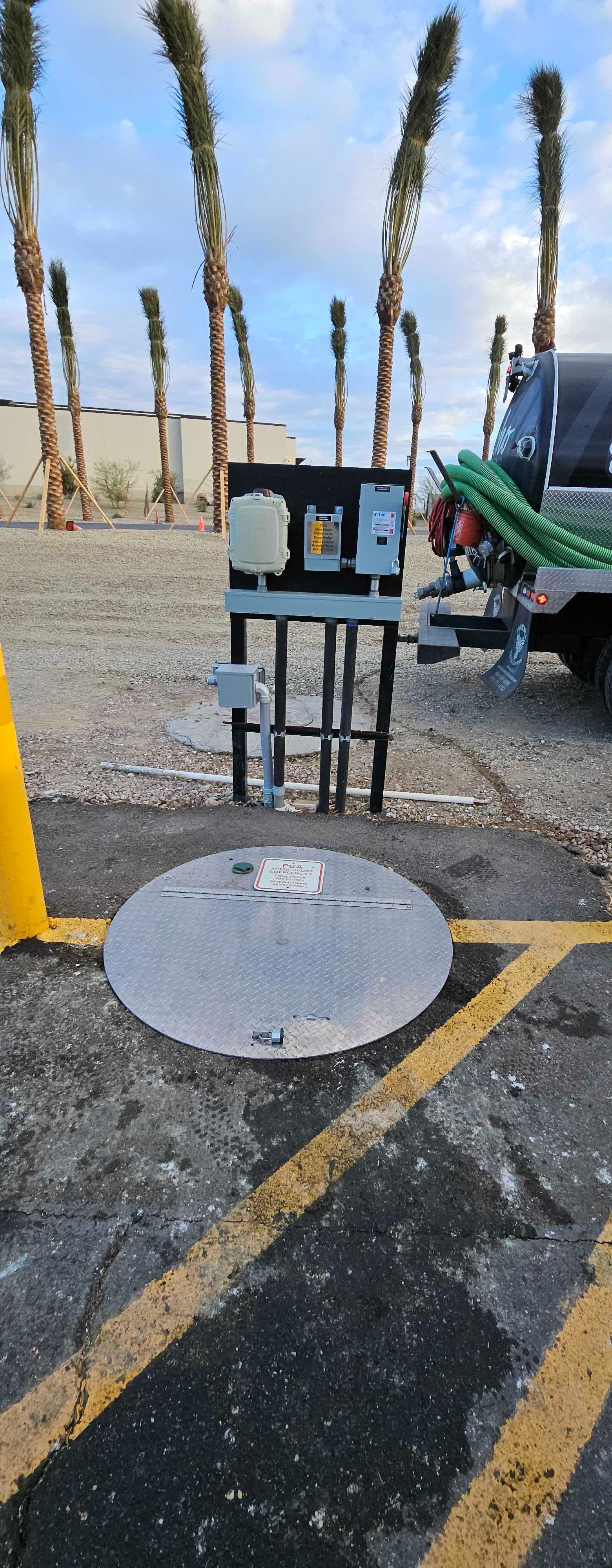 A manhole cover is sitting in a parking lot next to a truck.
