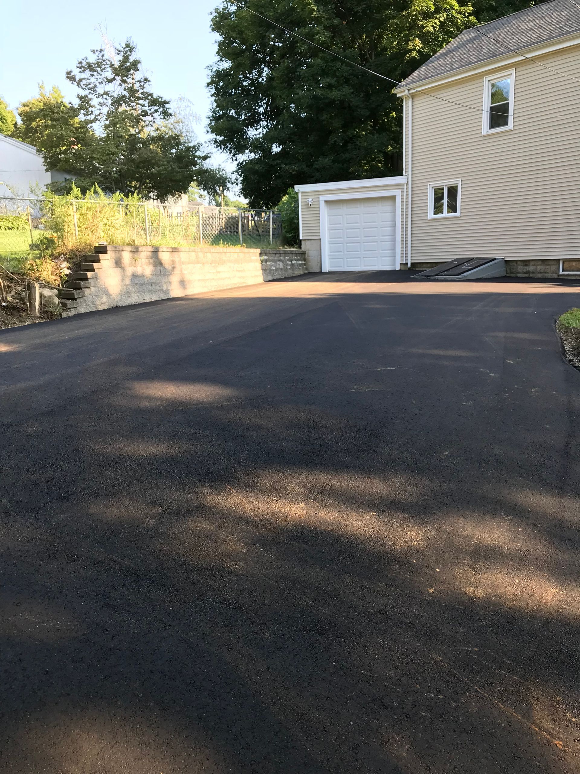 A house with a garage and a driveway in front of it
