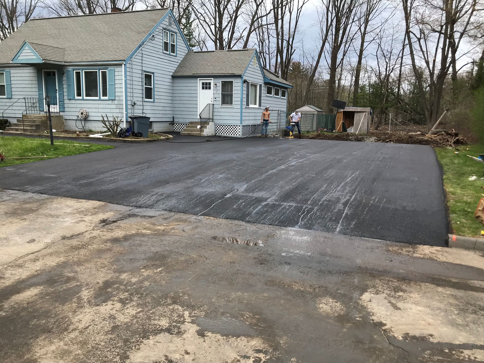 A house with a large driveway in front of it.