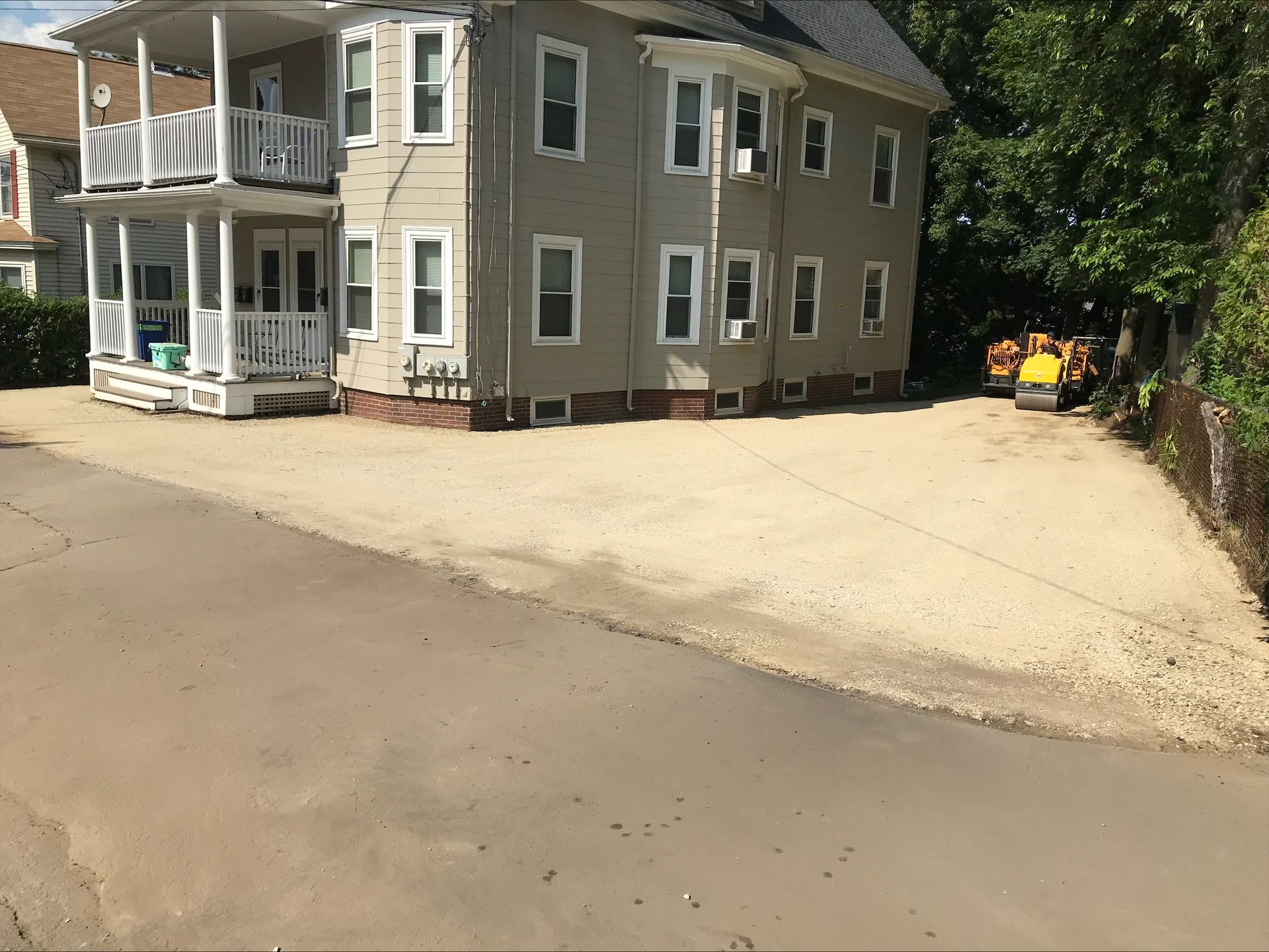 A large house with a large driveway in front of it.