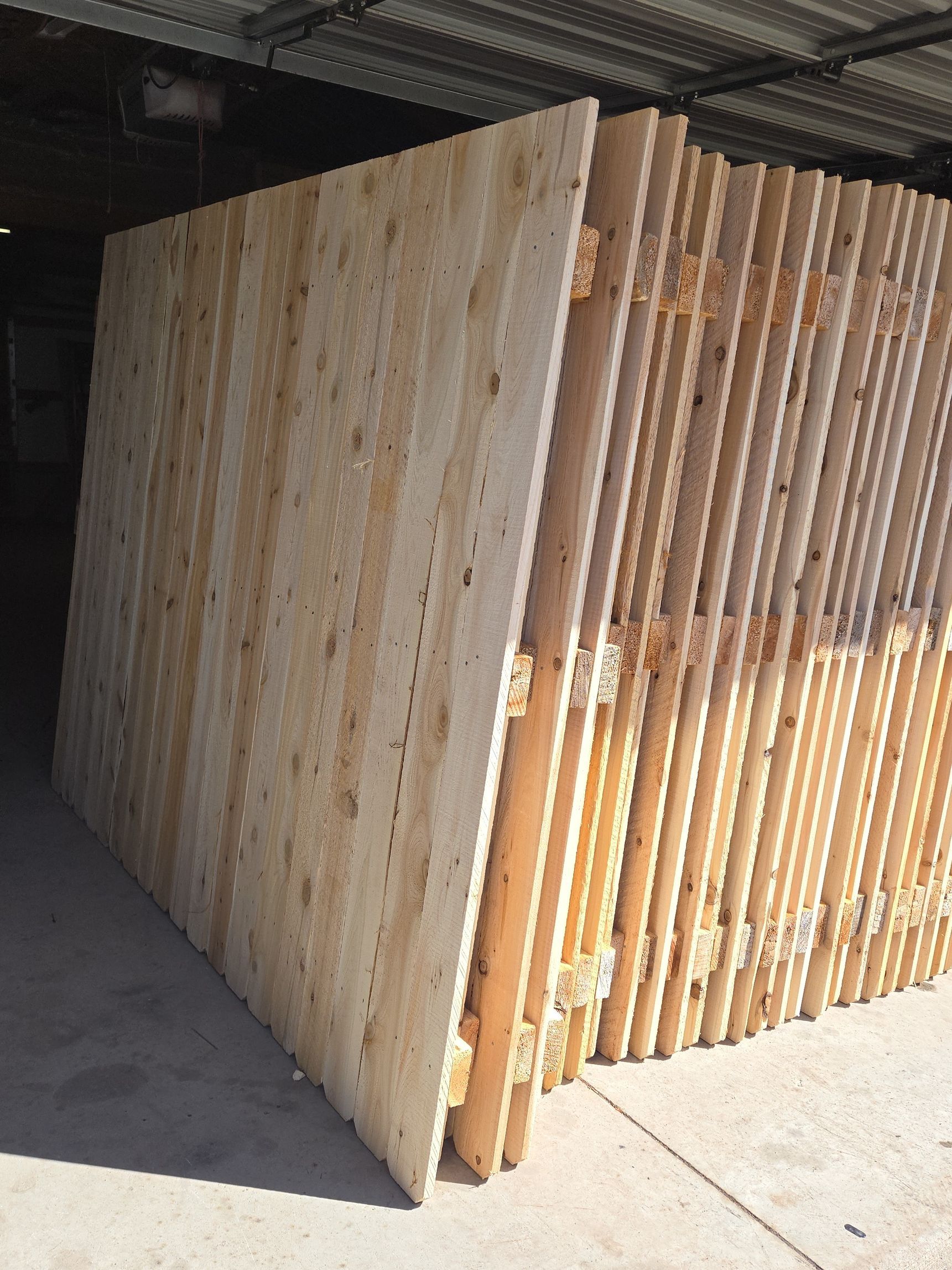 Stack of beige stone slabs, with textured surface and visible edges.