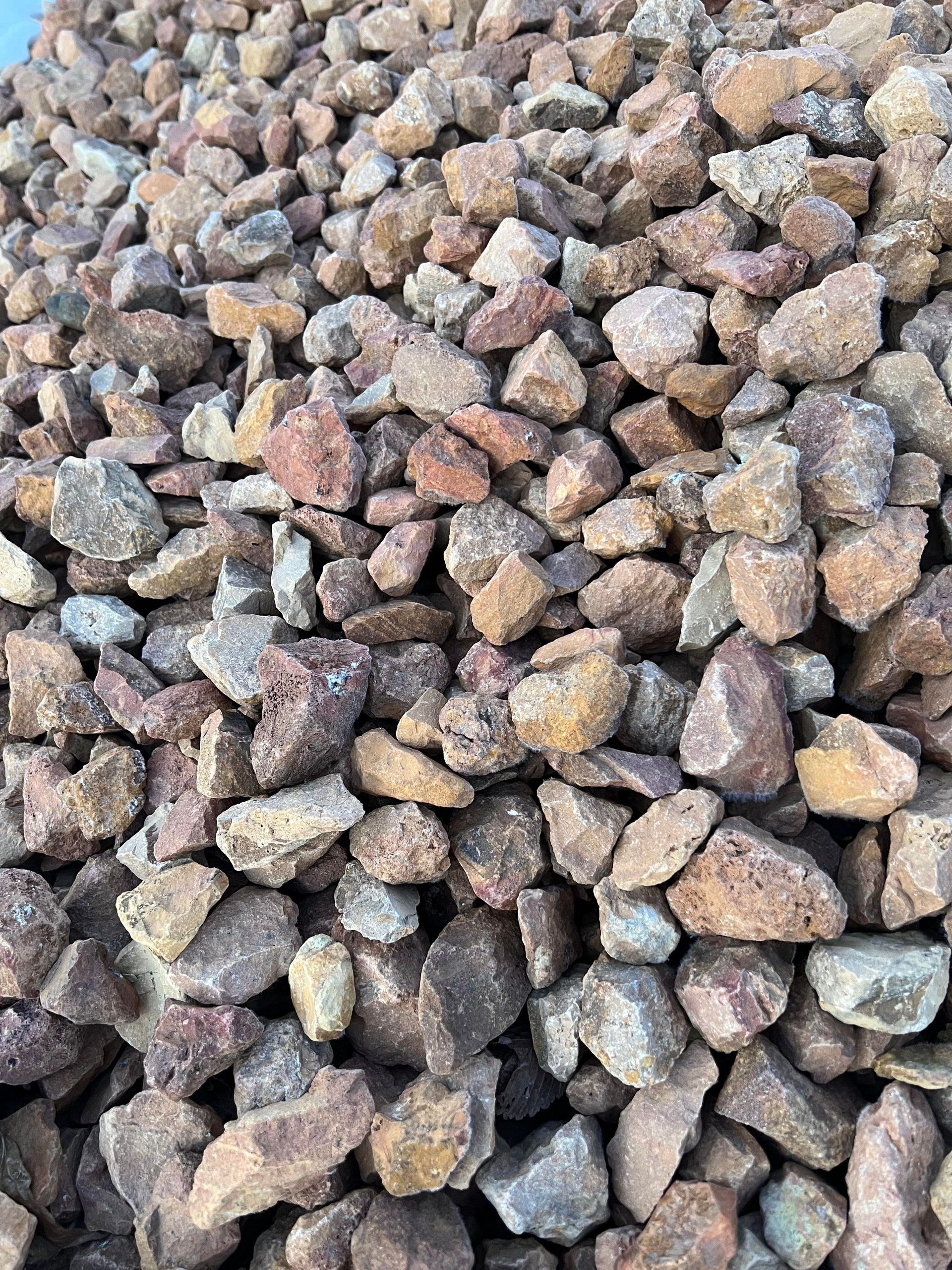 A pile of rocks is sitting on the ground.