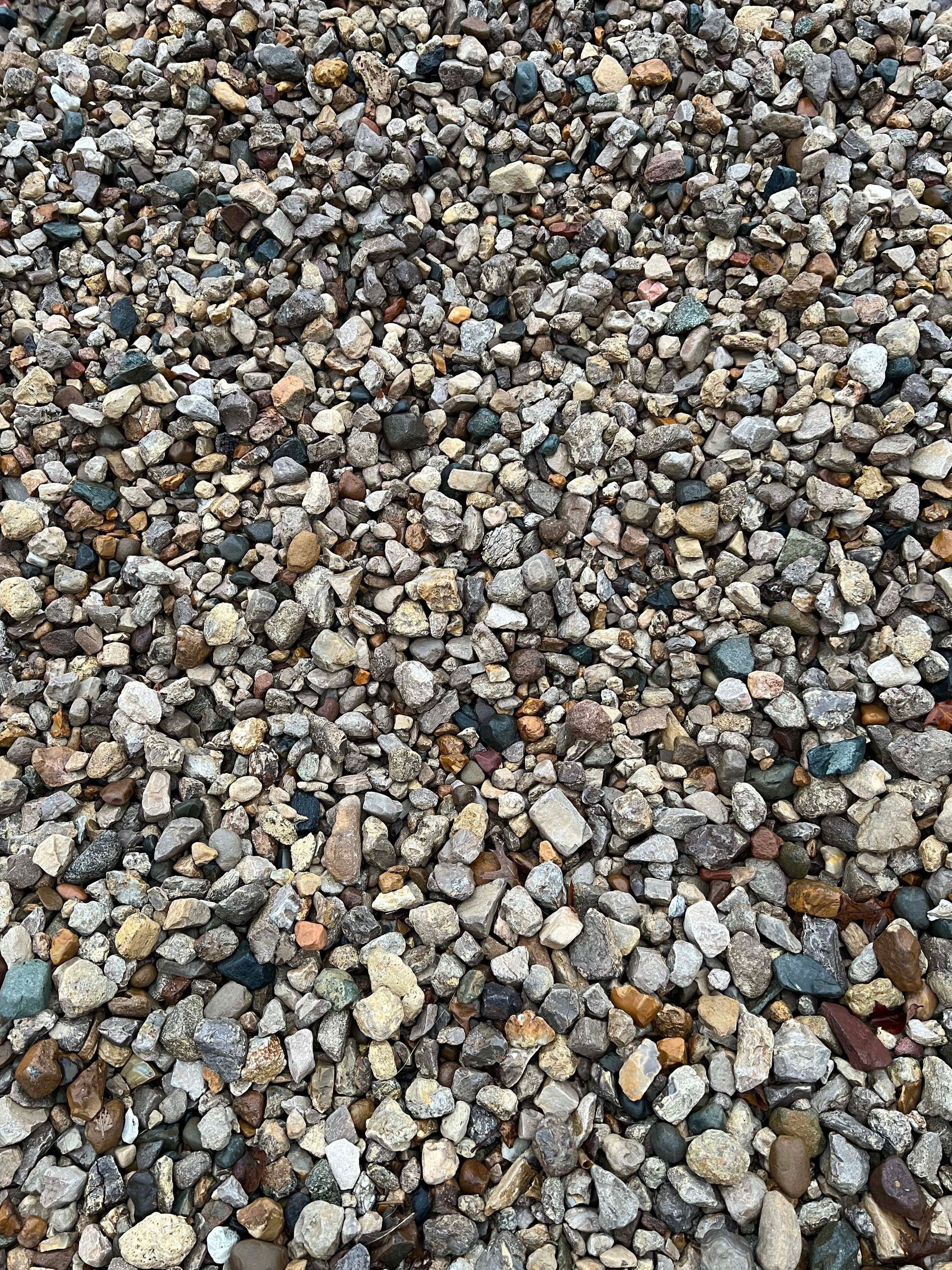 A pile of rocks is sitting on the ground.