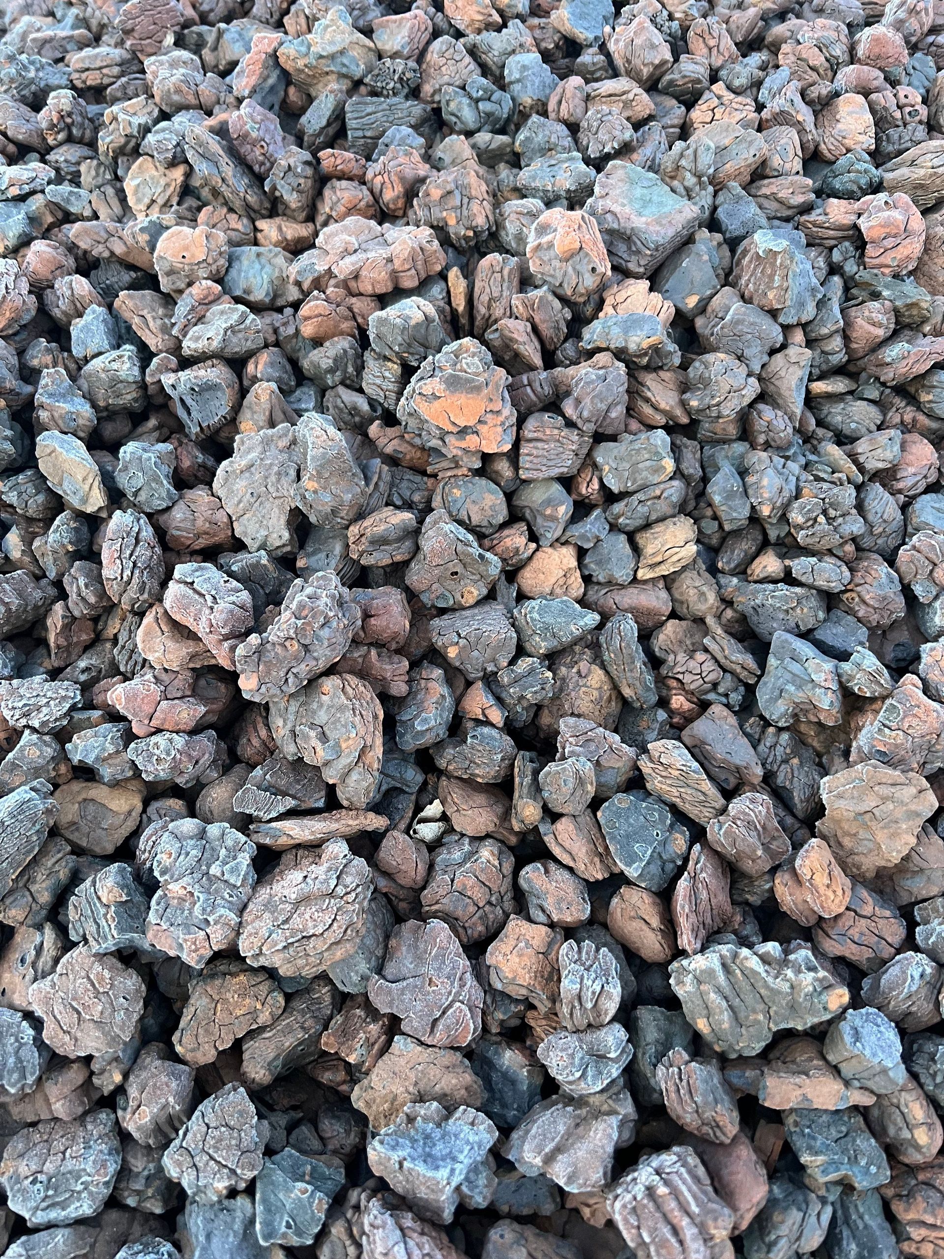 A pile of rocks is sitting on the ground.