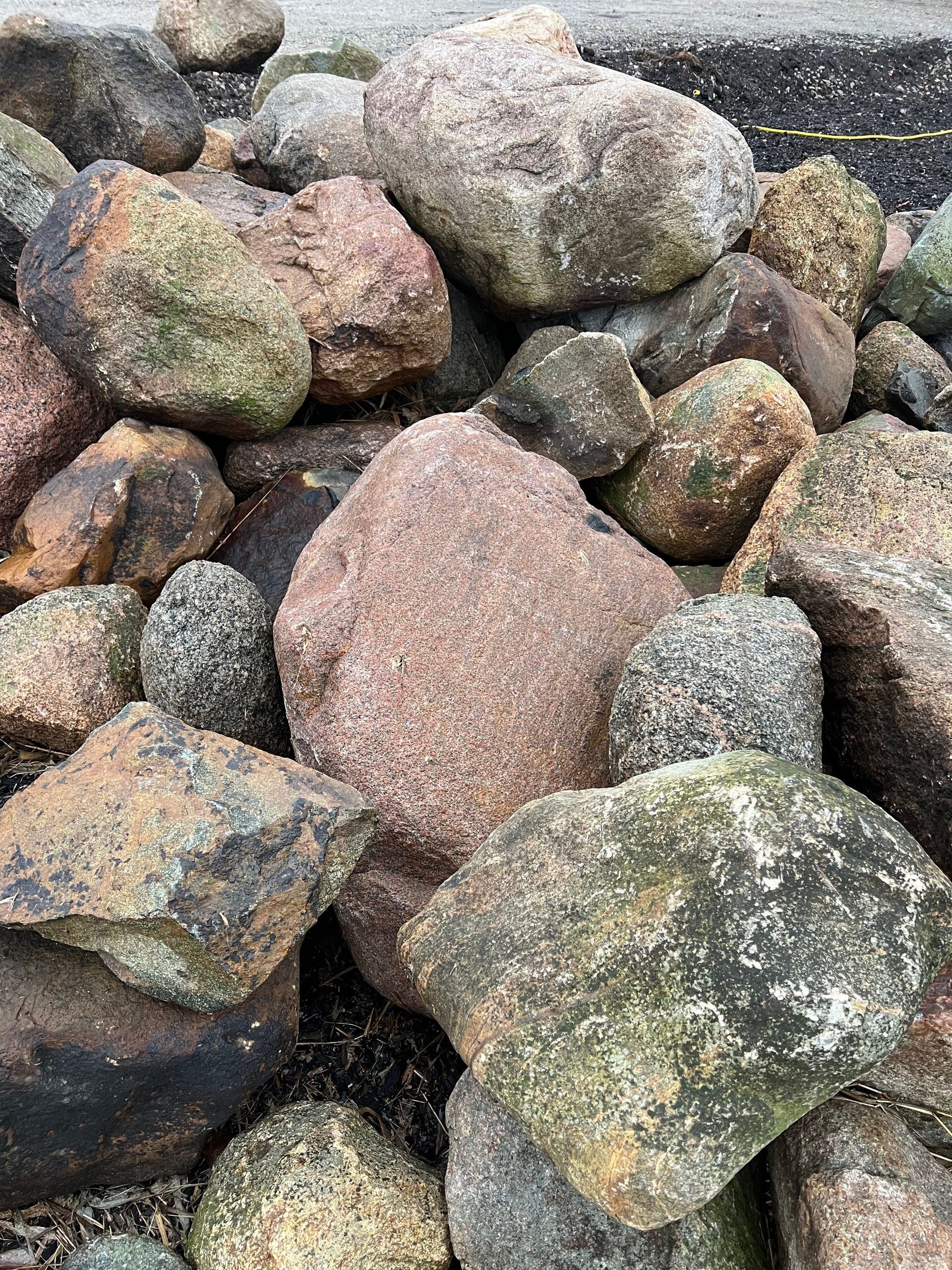A pile of rocks is sitting on the ground.