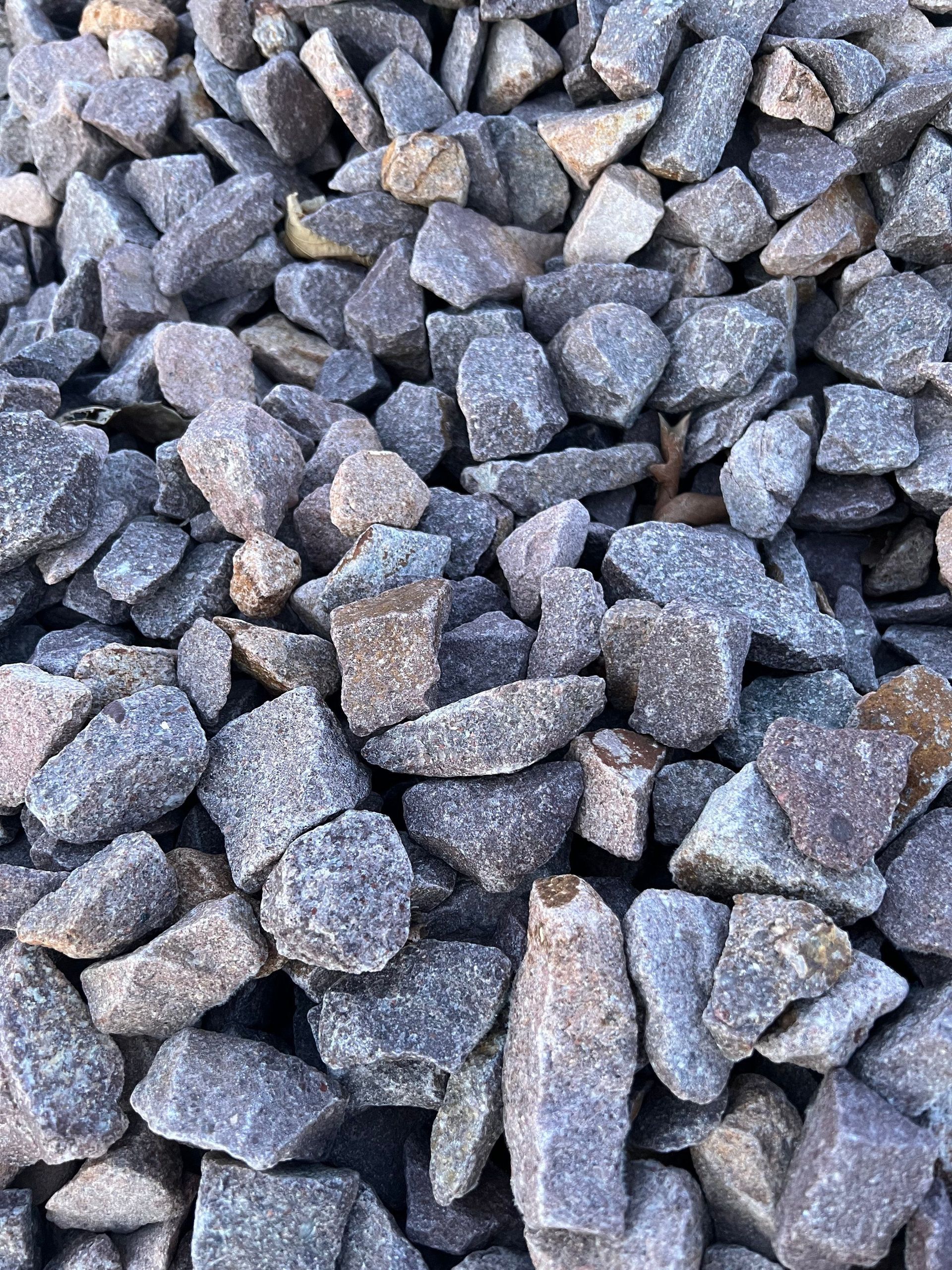 A pile of rocks is sitting on the ground.