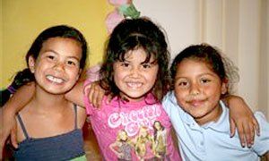 Three little kids smiling