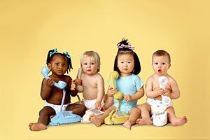 Infants holding telephoe in front of a yellow background