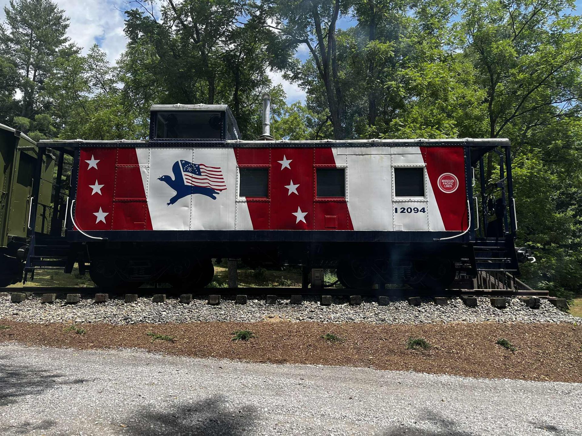 Caboose painted red, white, and blue with stars.