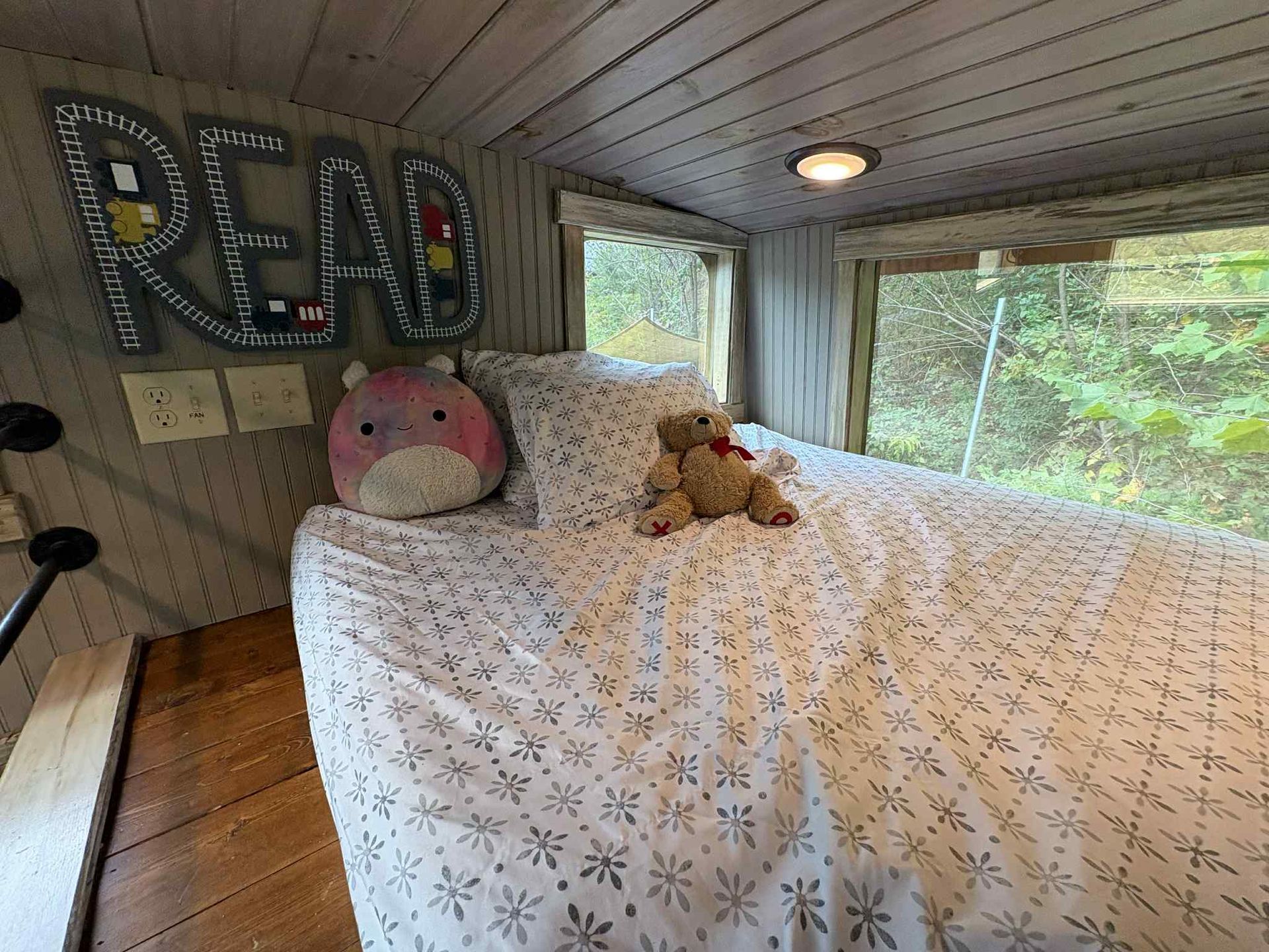 Cozy treehouse bedroom with bed, pillows, and a