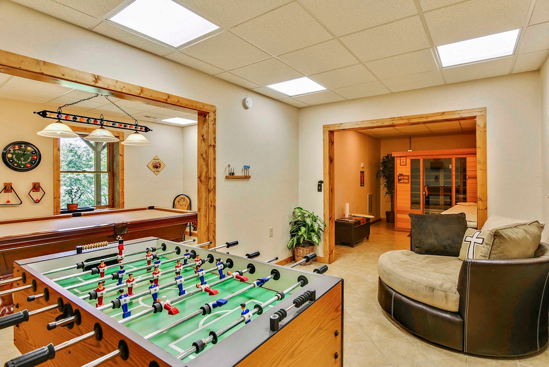 Game room with foosball table, pool table, and sauna.