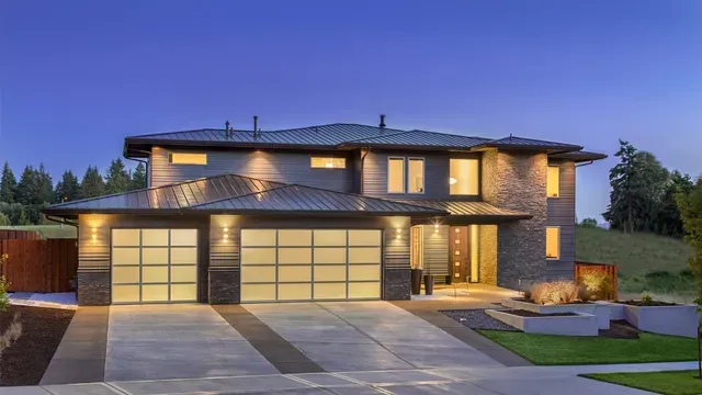 A large house with a lot of windows and a driveway