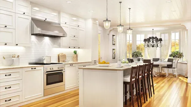 A kitchen with white cabinets , stainless steel appliances , wooden floors and a large island.